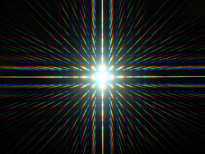 a lattice of light is visible in this picture. with little rainbows organizeds in the shape of a cross